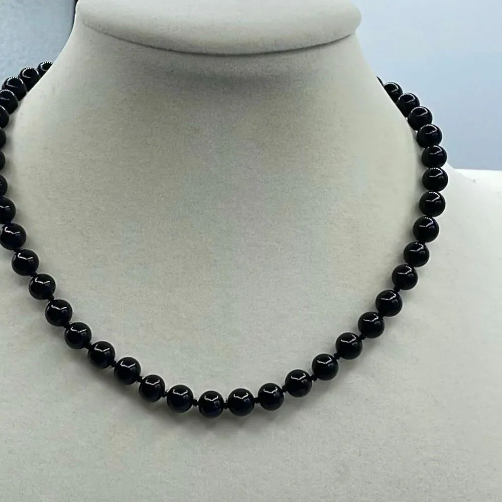 Vintage Monet black glass beaded necklace knotted. Logo tag.